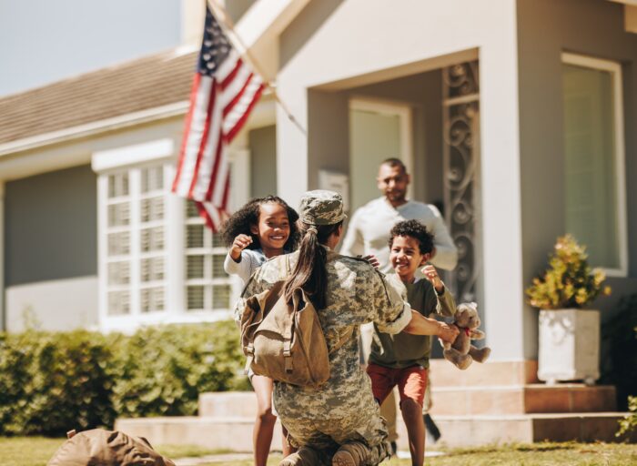 Servicewoman,Embracing,Her,Children,After,Arriving,Home,From,The,Army.