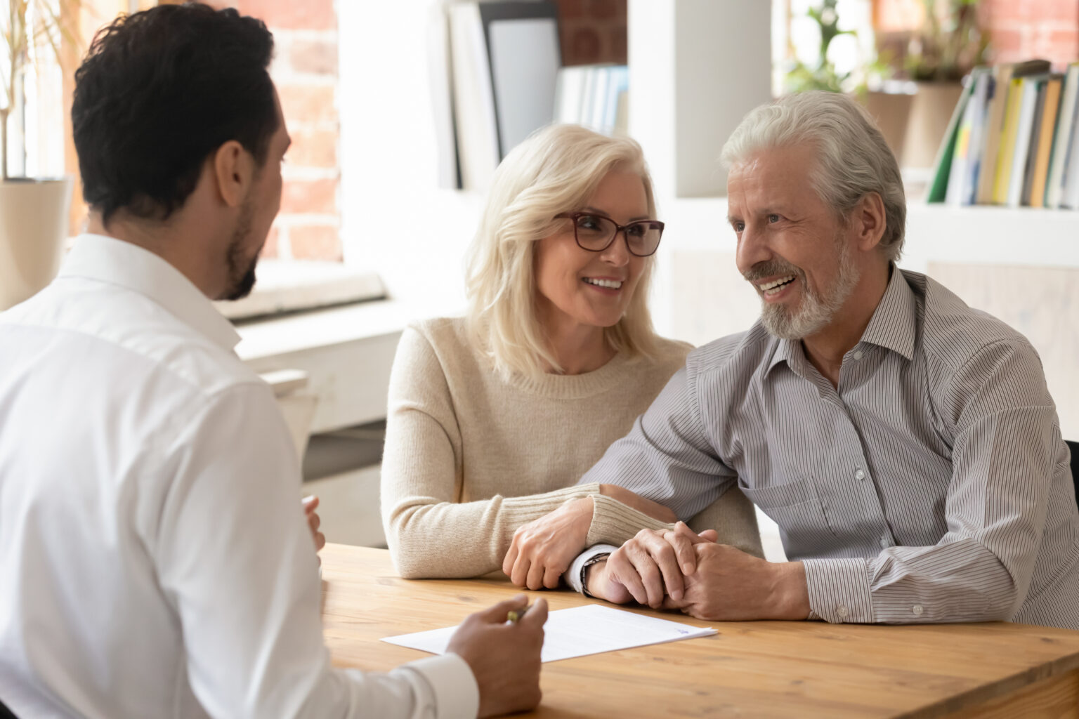 Senior Homeowners Discussing a Reverse Mortgage Loan With a Local Counselor