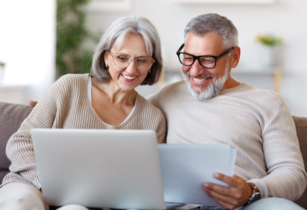 Pair of senior discussing their reverse mortgage options on the couch